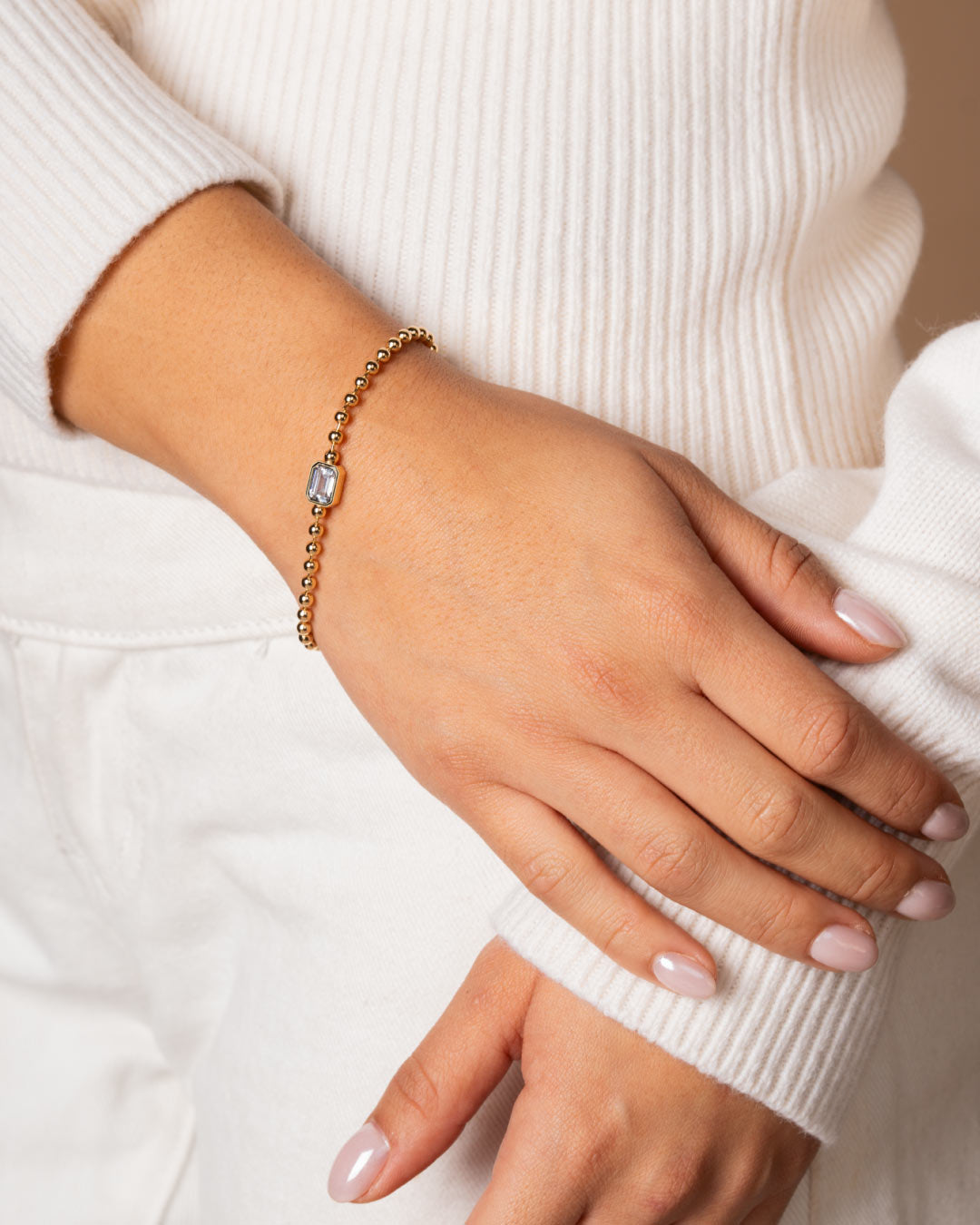 close up a model wearing the emerald-cut beaded bracelet by Camóre