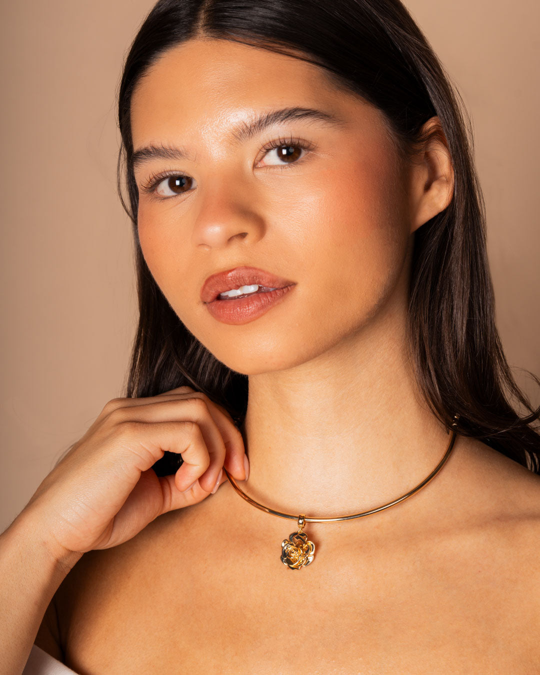 woman wearing a gold choker with a rose charm by Camóre