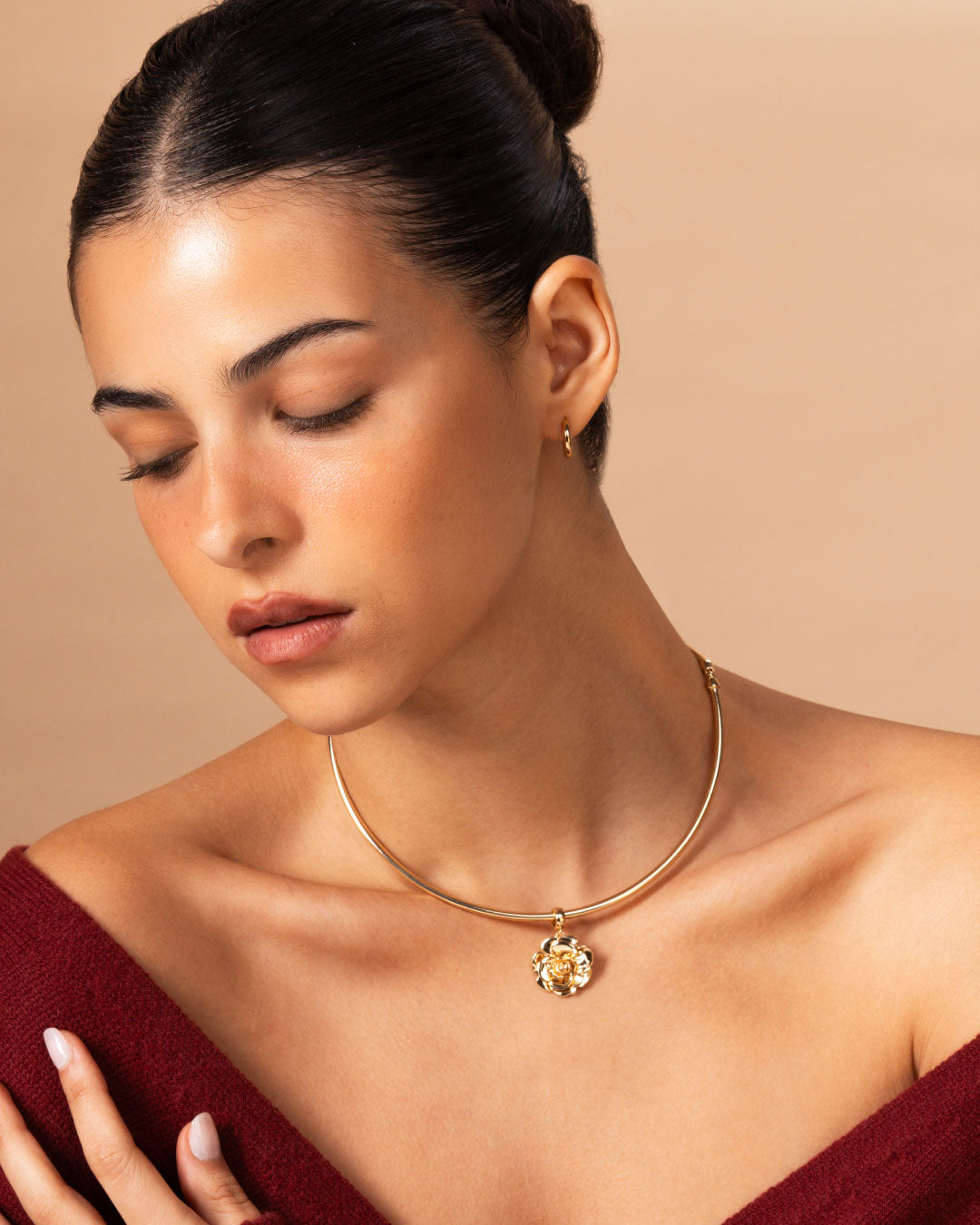 woman wearing a gold choker with a rose charm by Camóre