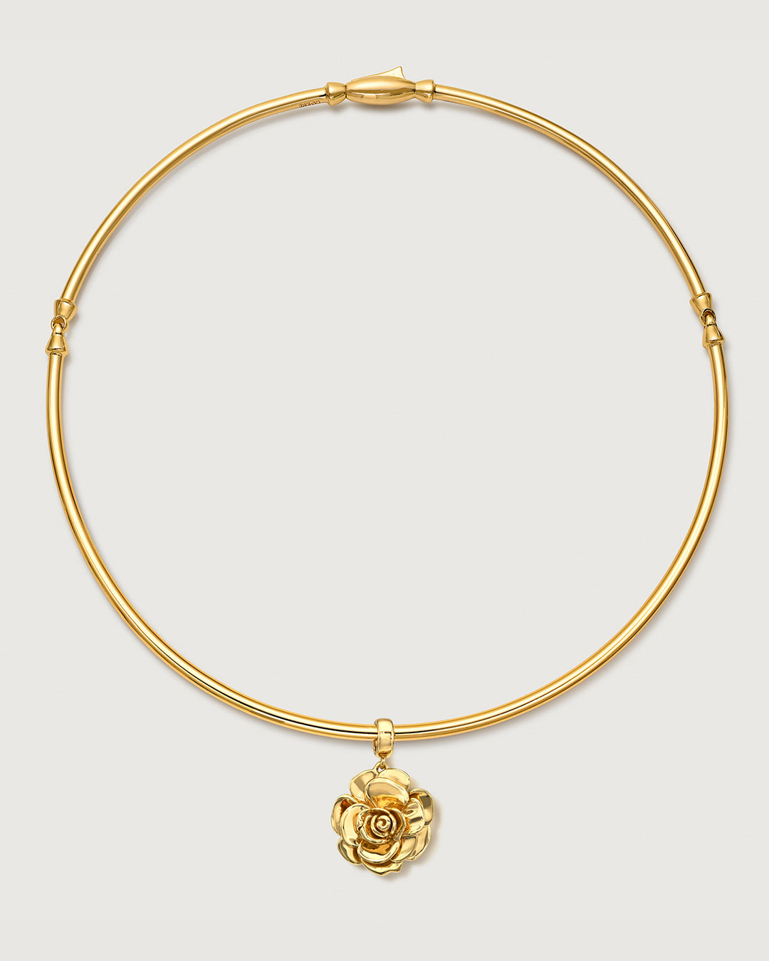 Gold choker with rose charm by Camóre on a white background