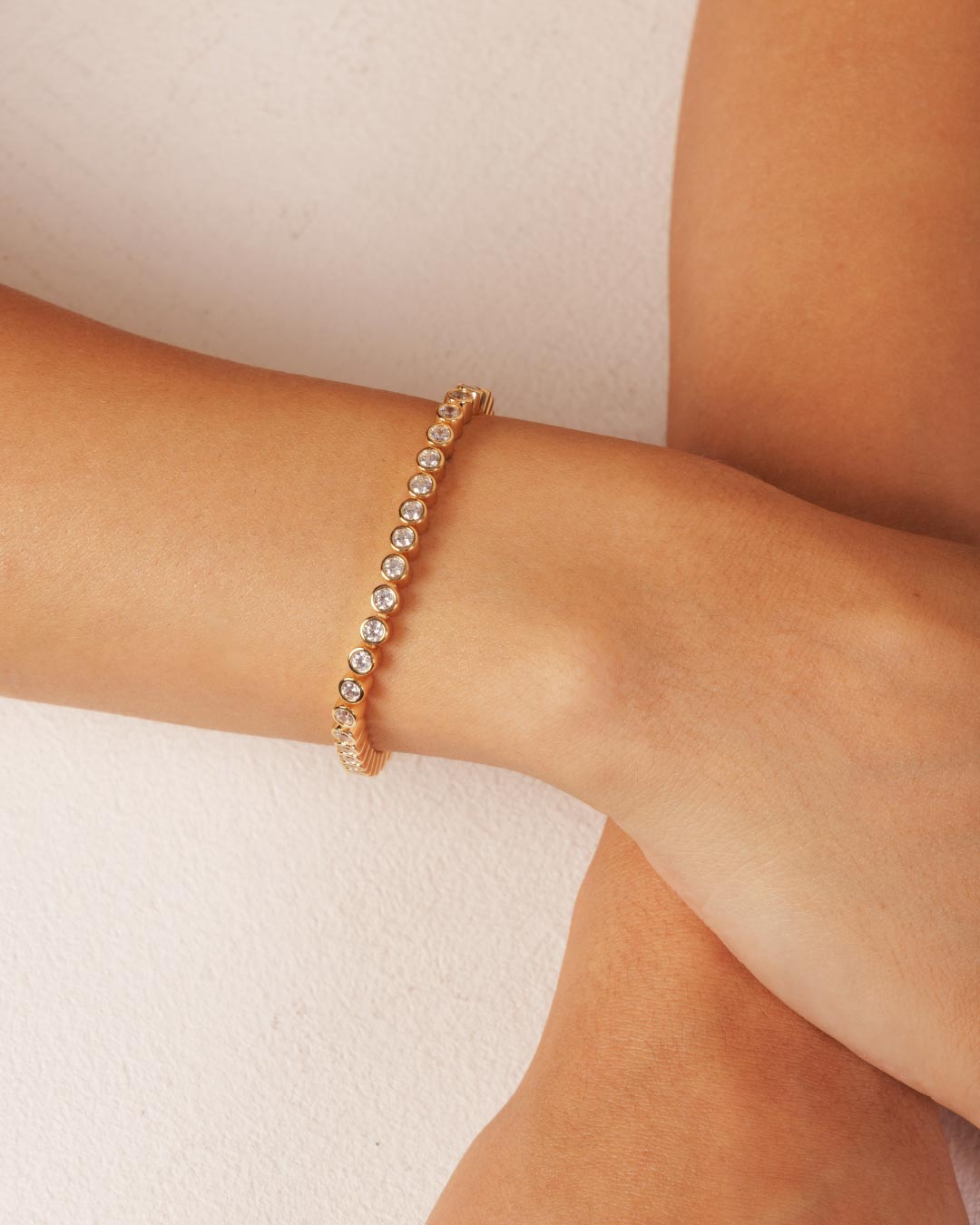 Close-up of the Camóre Axis Bracelet, a gold bezel-set tennis bracelet