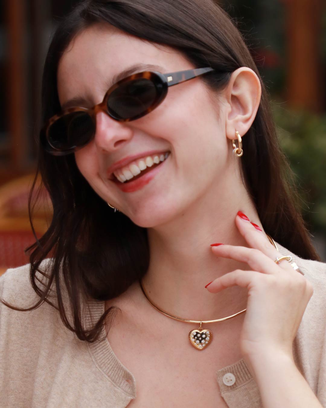woman wearing gold choker with heart shaped charm