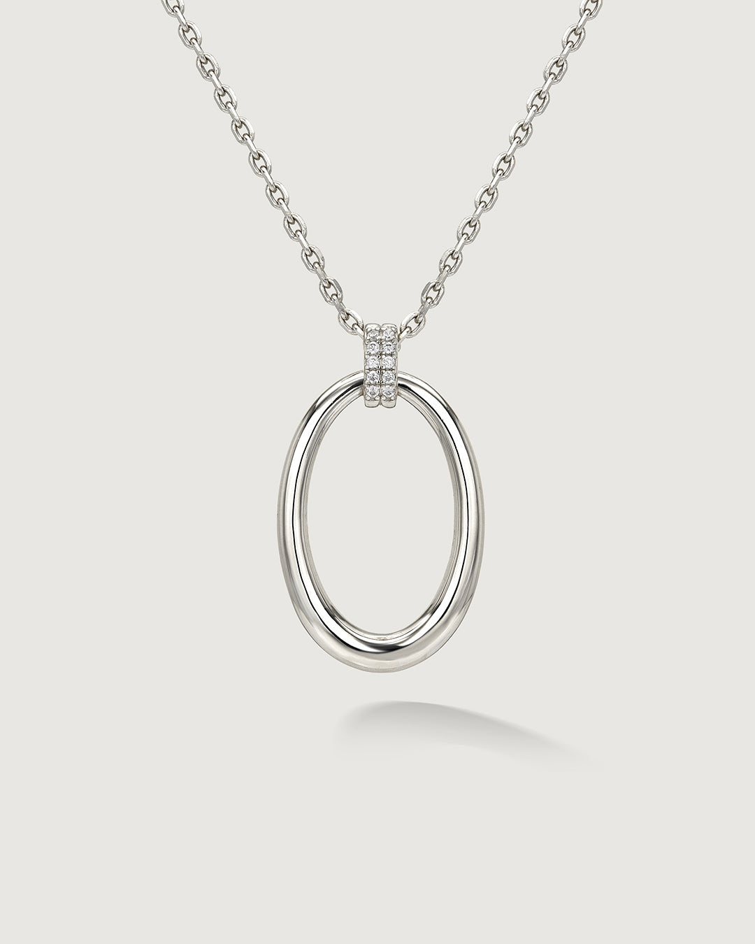 Silver open oval pendant necklace by Camóre on a white background